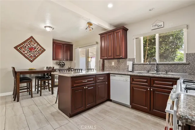 a kitchen with a sink window and cabinets