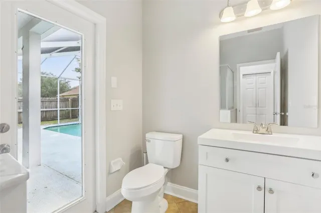 a bathroom with a toilet sink and a mirror