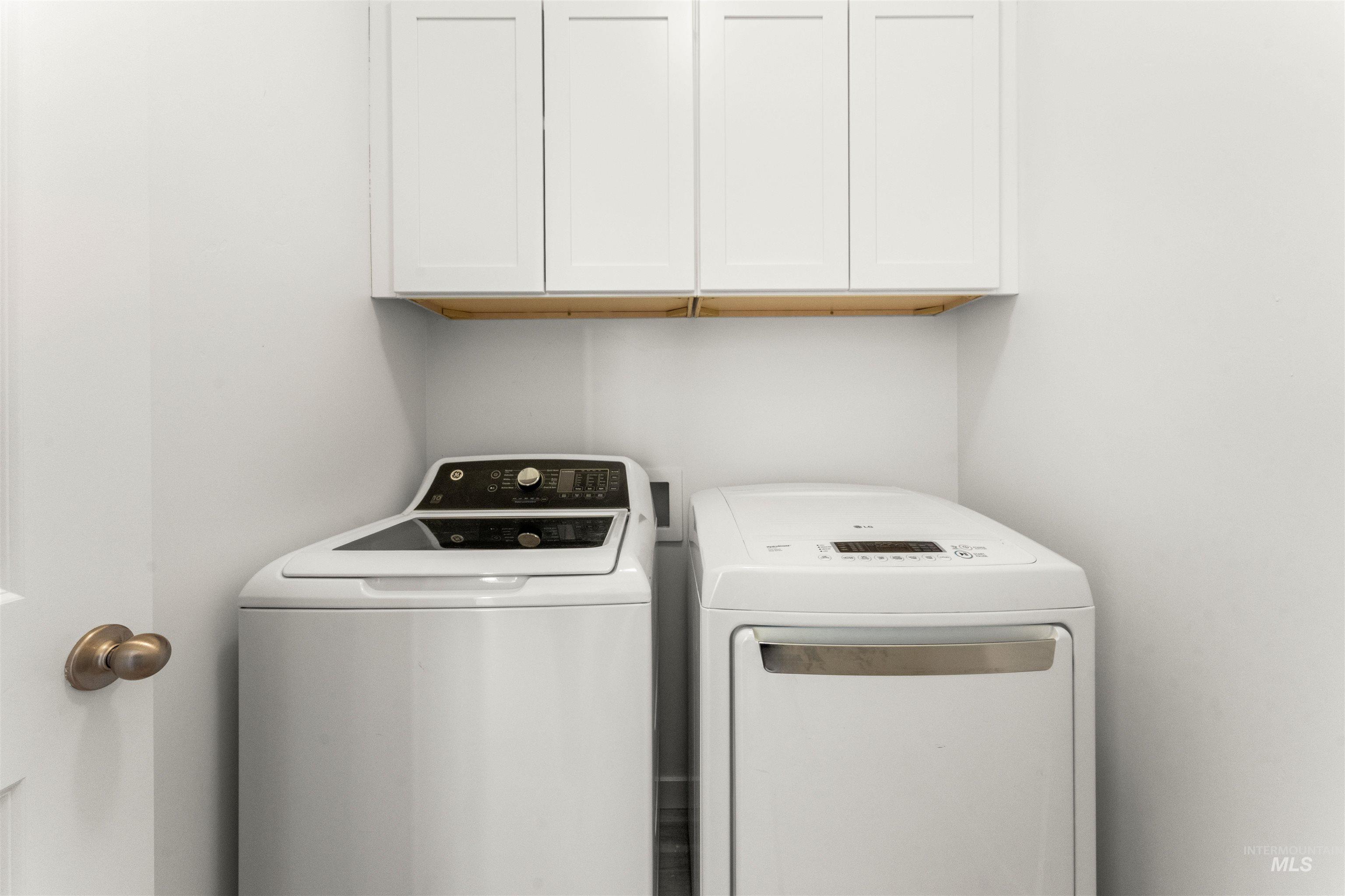 2040 West Gelding Street Middleton, ID 83644 - Photo 17 of 22 Laundry room featuring washing machine and clothes dryer and cabinet space