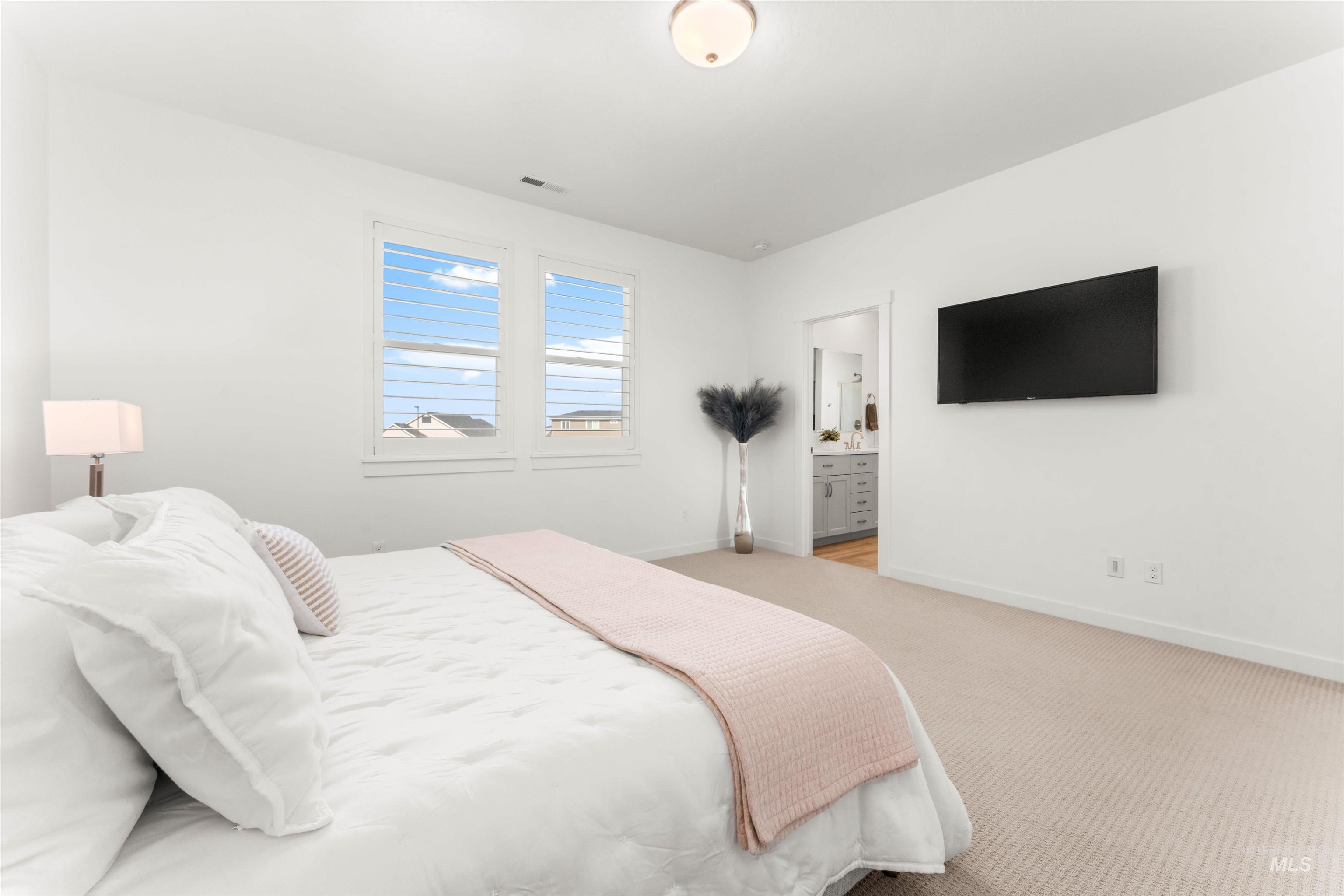 2040 West Gelding Street Middleton, ID 83644 - Photo 19 of 22 Bedroom with light colored carpet and ensuite bath