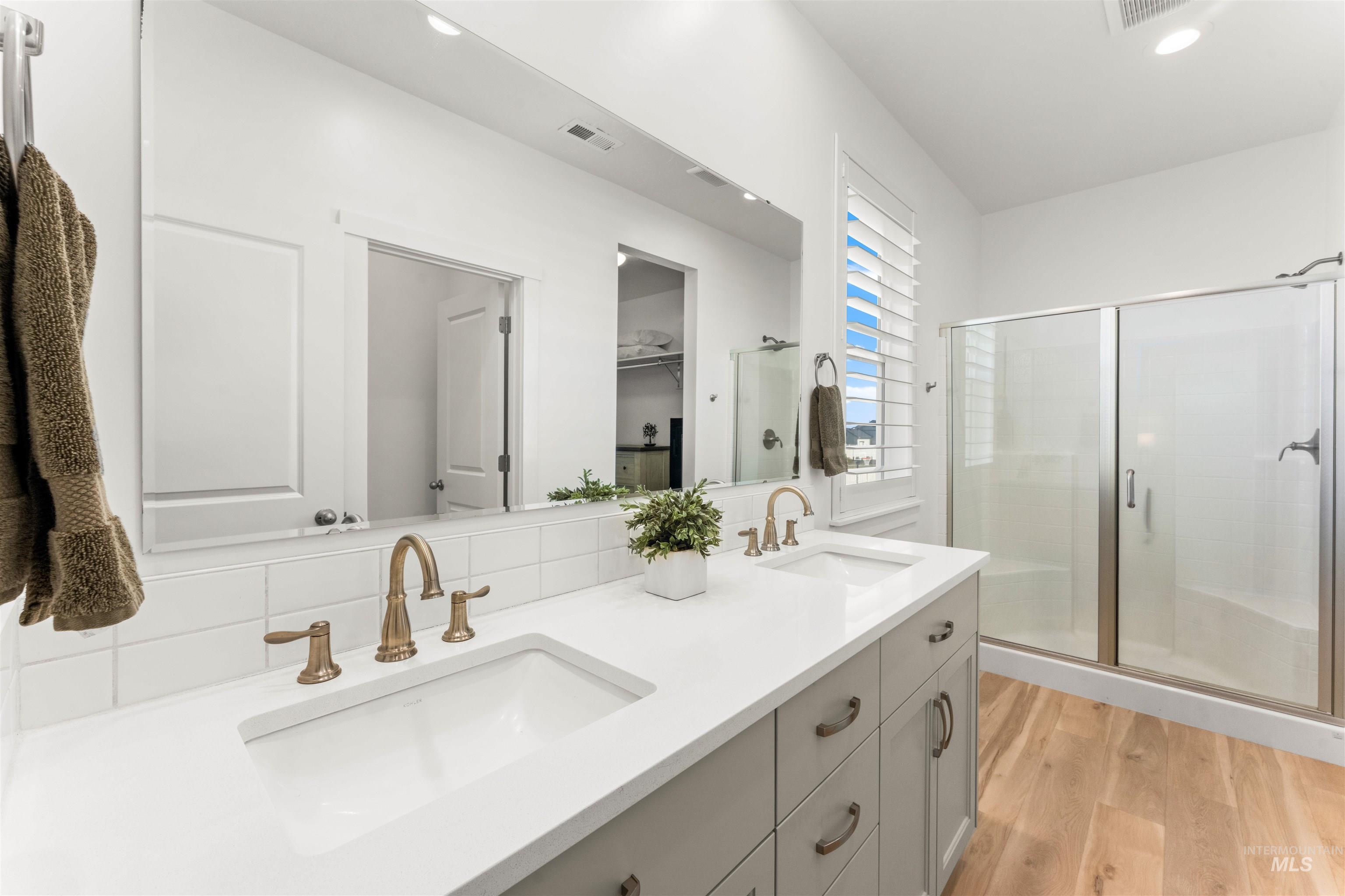 2040 West Gelding Street Middleton, ID 83644 - Photo 20 of 22 Bathroom with a shower stall, double vanity, light wood finished floors, a spacious closet, and recessed lighting
