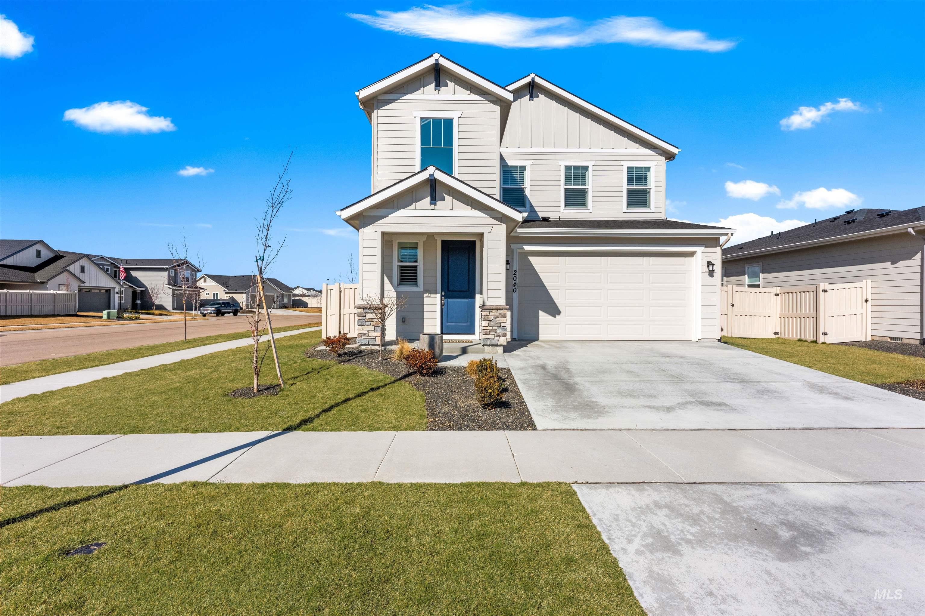 2040 West Gelding Street Middleton, ID 83644 - Photo 2 of 22 View of front of house featuring board and batten siding, stone siding, concrete driveway, a gate, and a garage