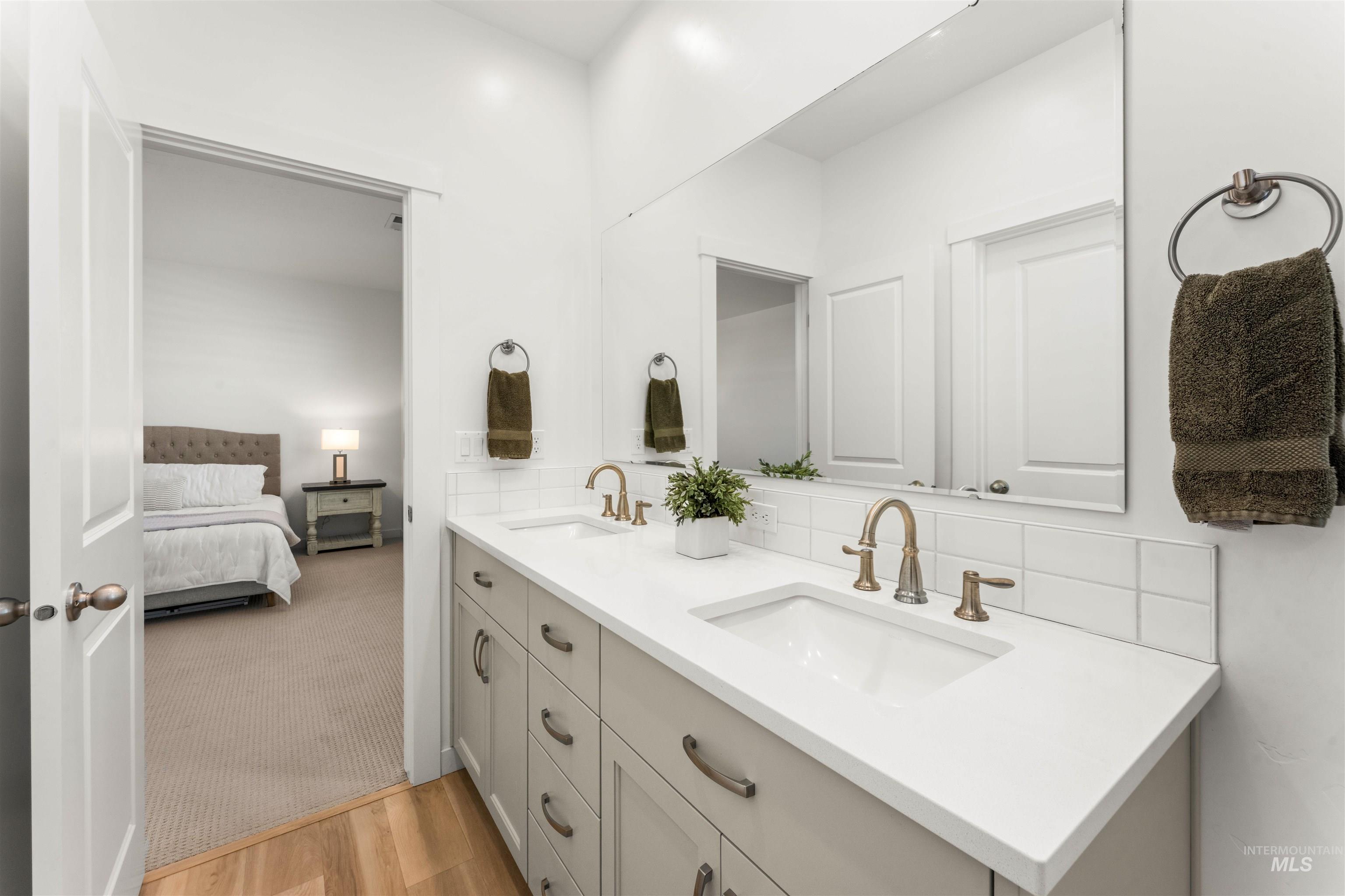 2040 West Gelding Street Middleton, ID 83644 - Photo 22 of 22 Bathroom with double vanity, ensuite bath, light wood-style floors, and light carpet