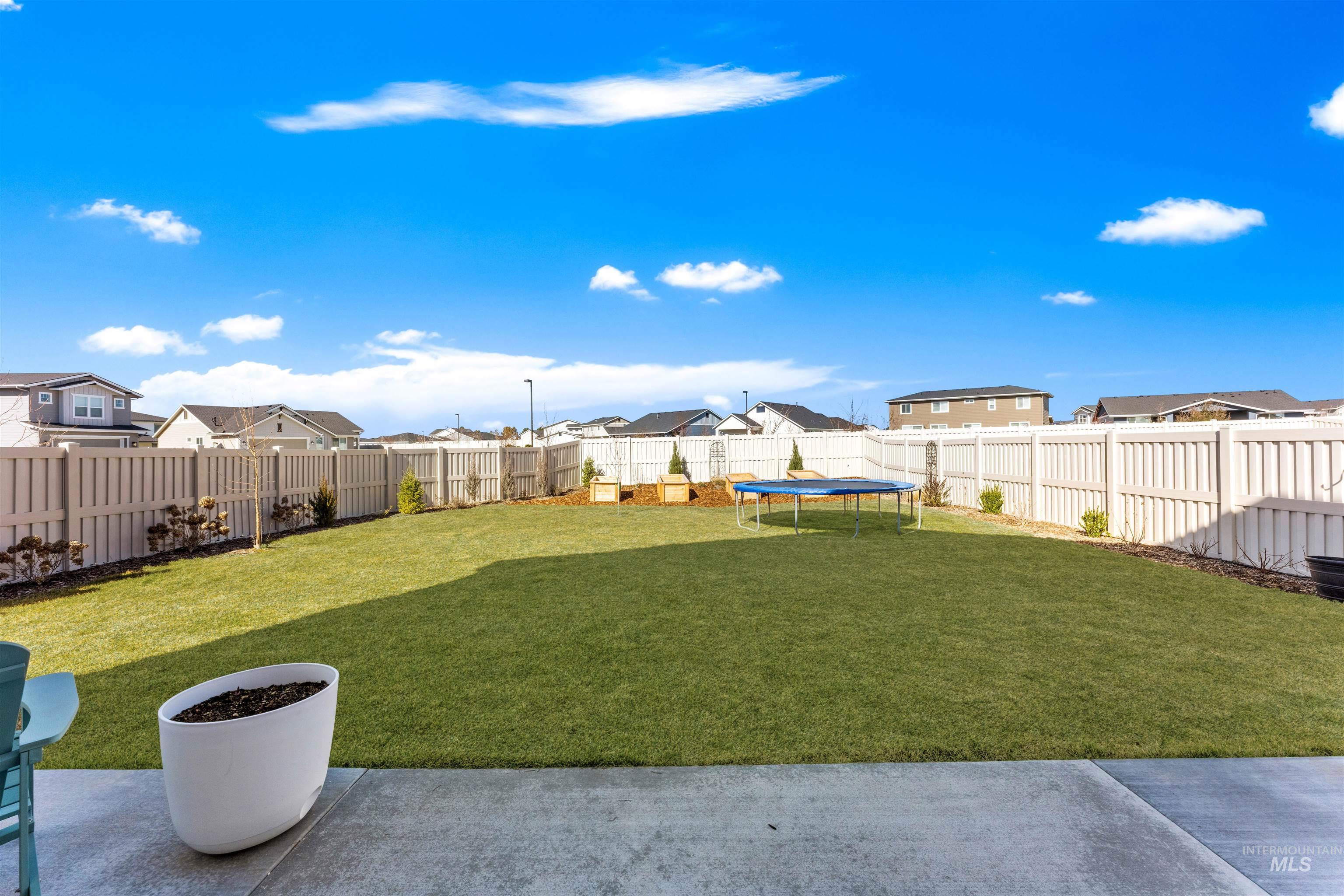2040 West Gelding Street Middleton, ID 83644 - Photo 3 of 22 Fenced backyard with a residential view and a trampoline