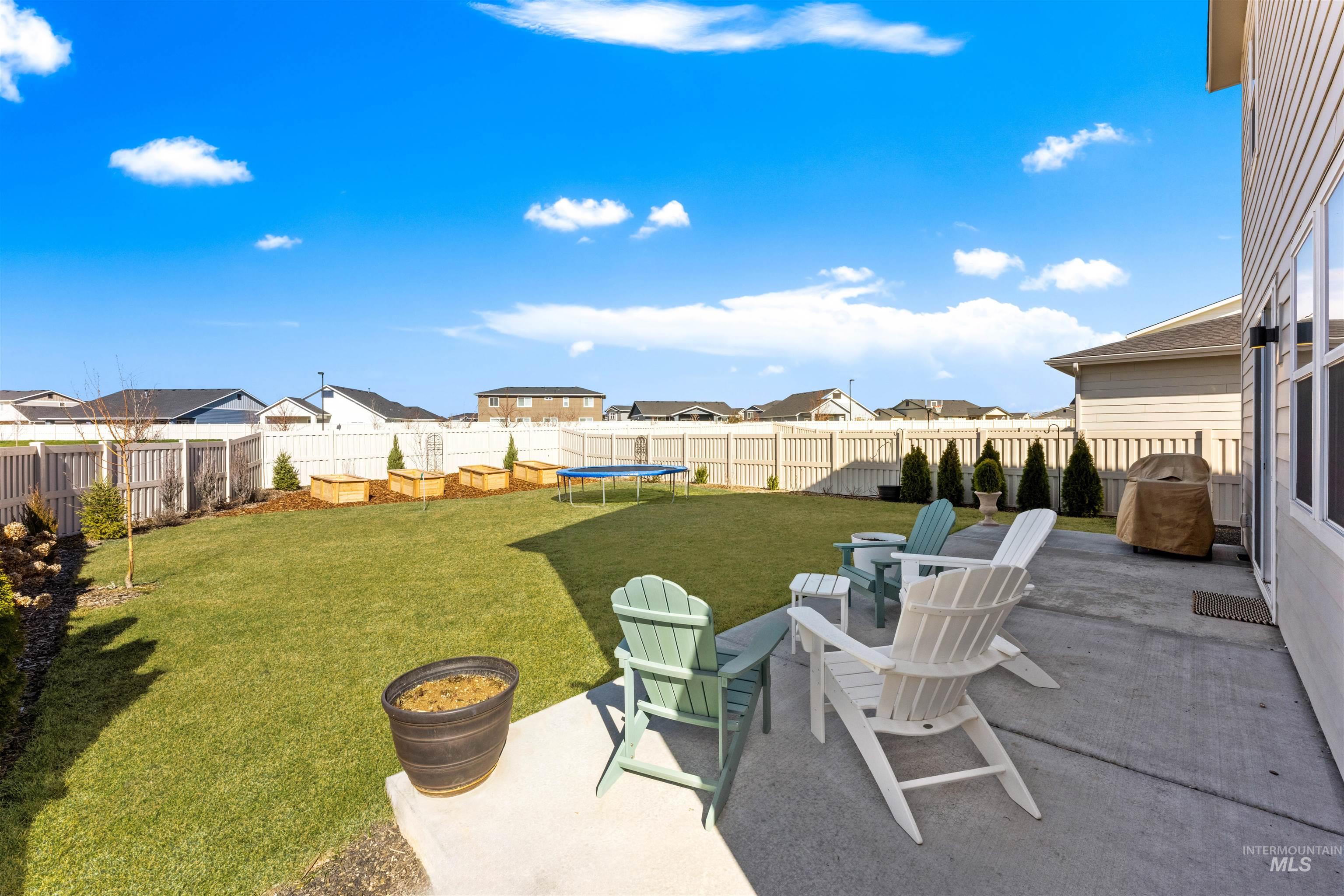 2040 West Gelding Street Middleton, ID 83644 - Photo 6 of 22 Fenced backyard with a patio area, a trampoline, and a residential view