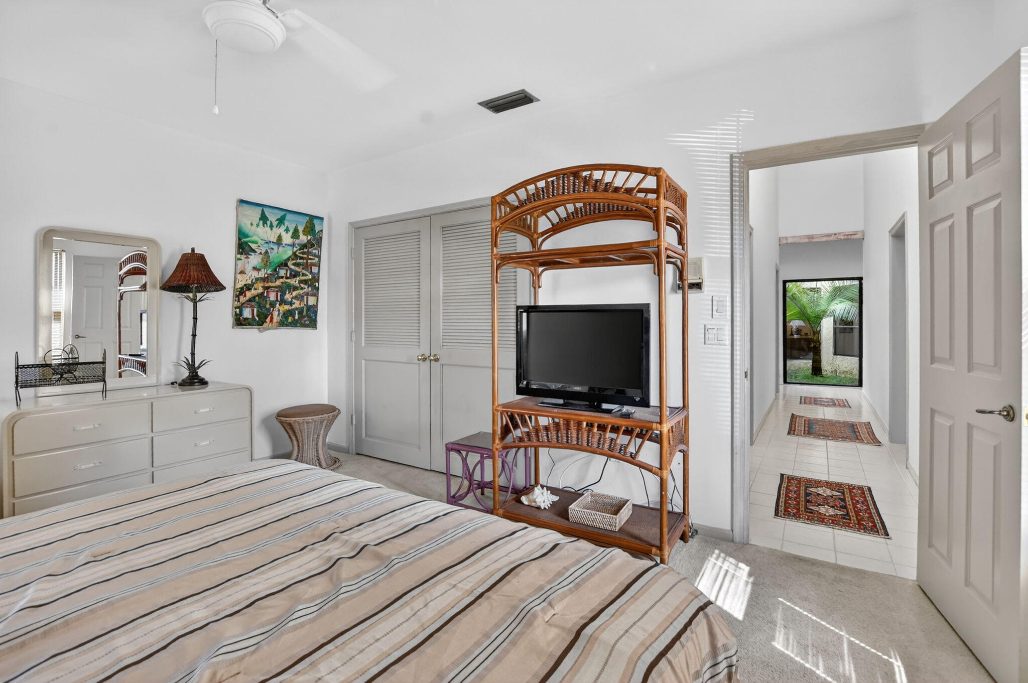 22519 Esplanada Circle, Unit W Boca Raton, FL 33433 - Photo 39 of 57 a bedroom with a bed and a flat screen tv