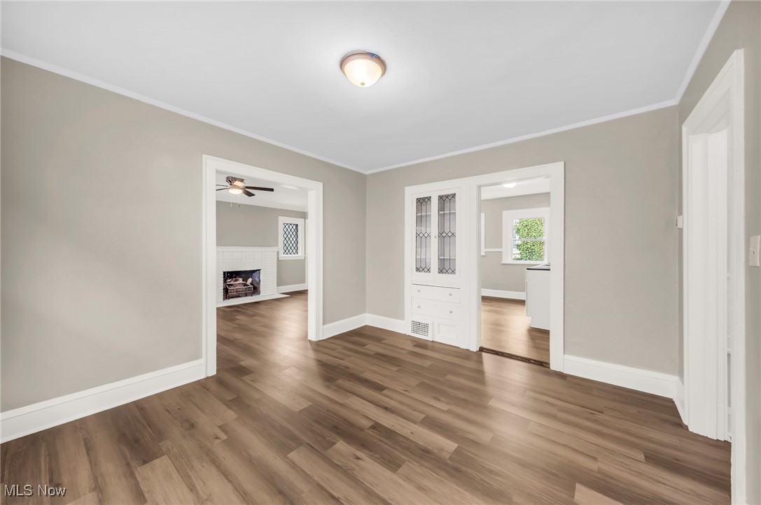 3528 Daleford Road Cleveland, OH 44120 - Photo 18 of 30 Unfurnished room with ceiling fan, wood finished floors, baseboards, a fireplace, and ornamental molding