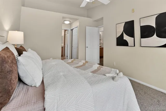 a bedroom with a bed and wall painting