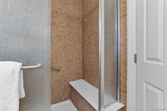 a bathroom with a shower and a toilet