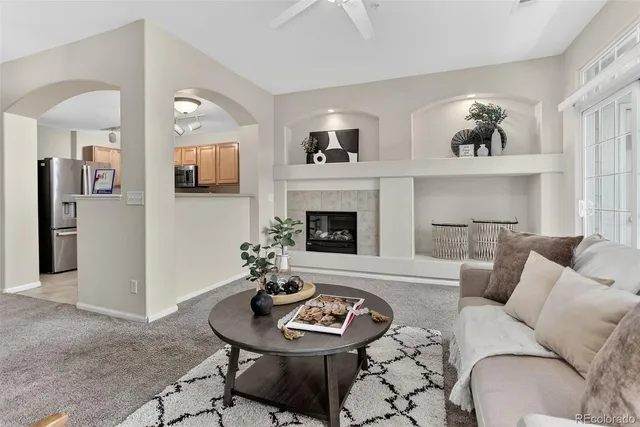 a living room with furniture and a fireplace