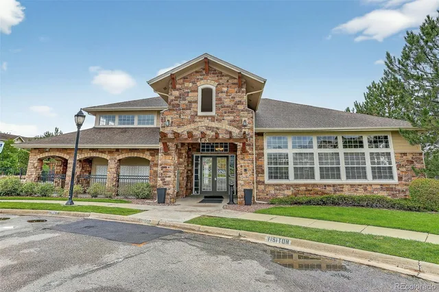 a front view of a house with a garden and plants
