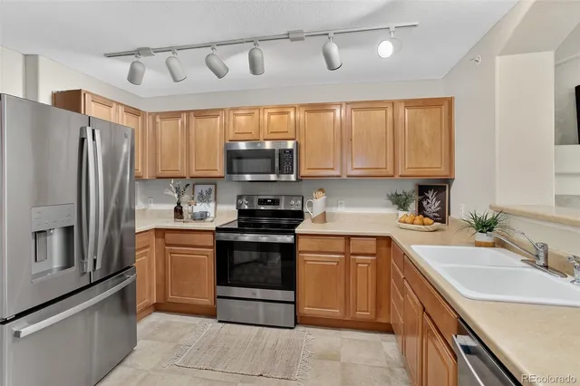 a kitchen with a sink appliances and cabinets