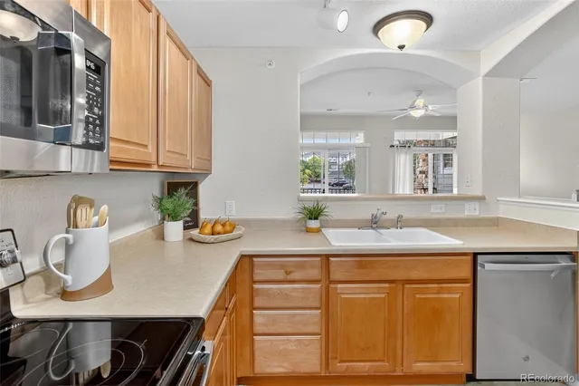 a kitchen with stainless steel appliances granite countertop a sink and cabinets