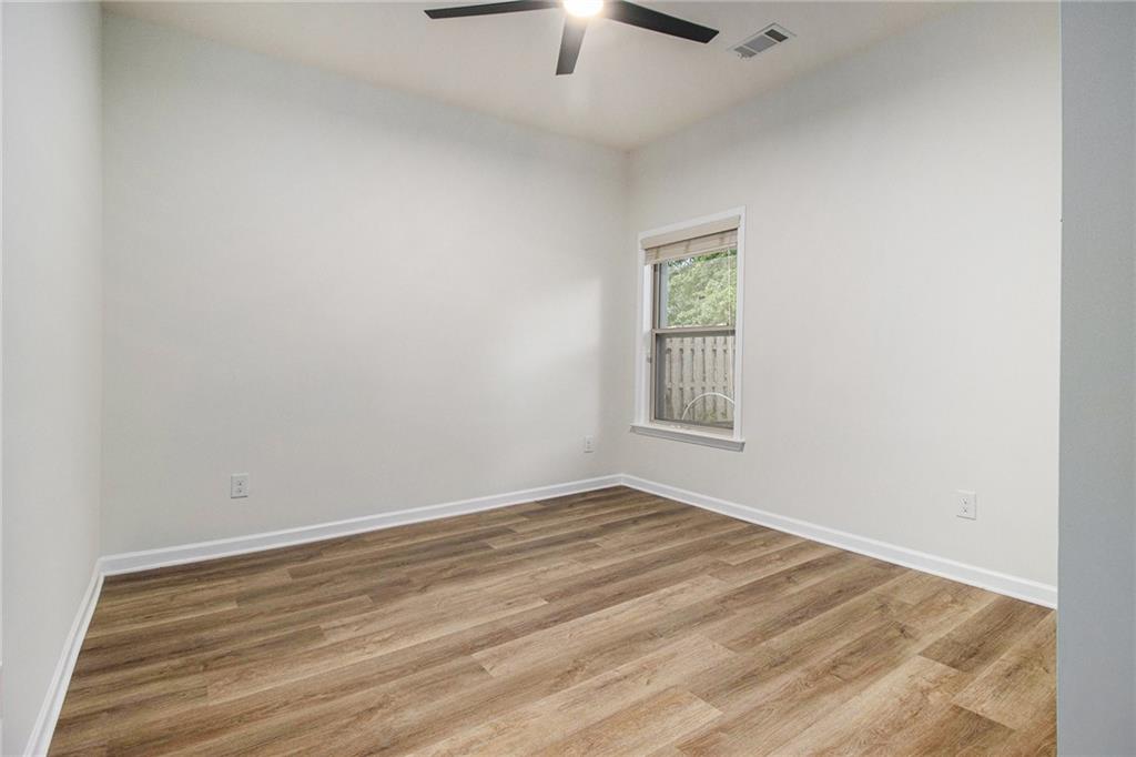 218 Third Avenue Avondale Estates, GA 30002 - Photo 17 of 26 an empty room with a window and chandelier fan