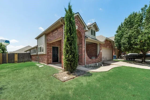 a front view of house with a garden and patio