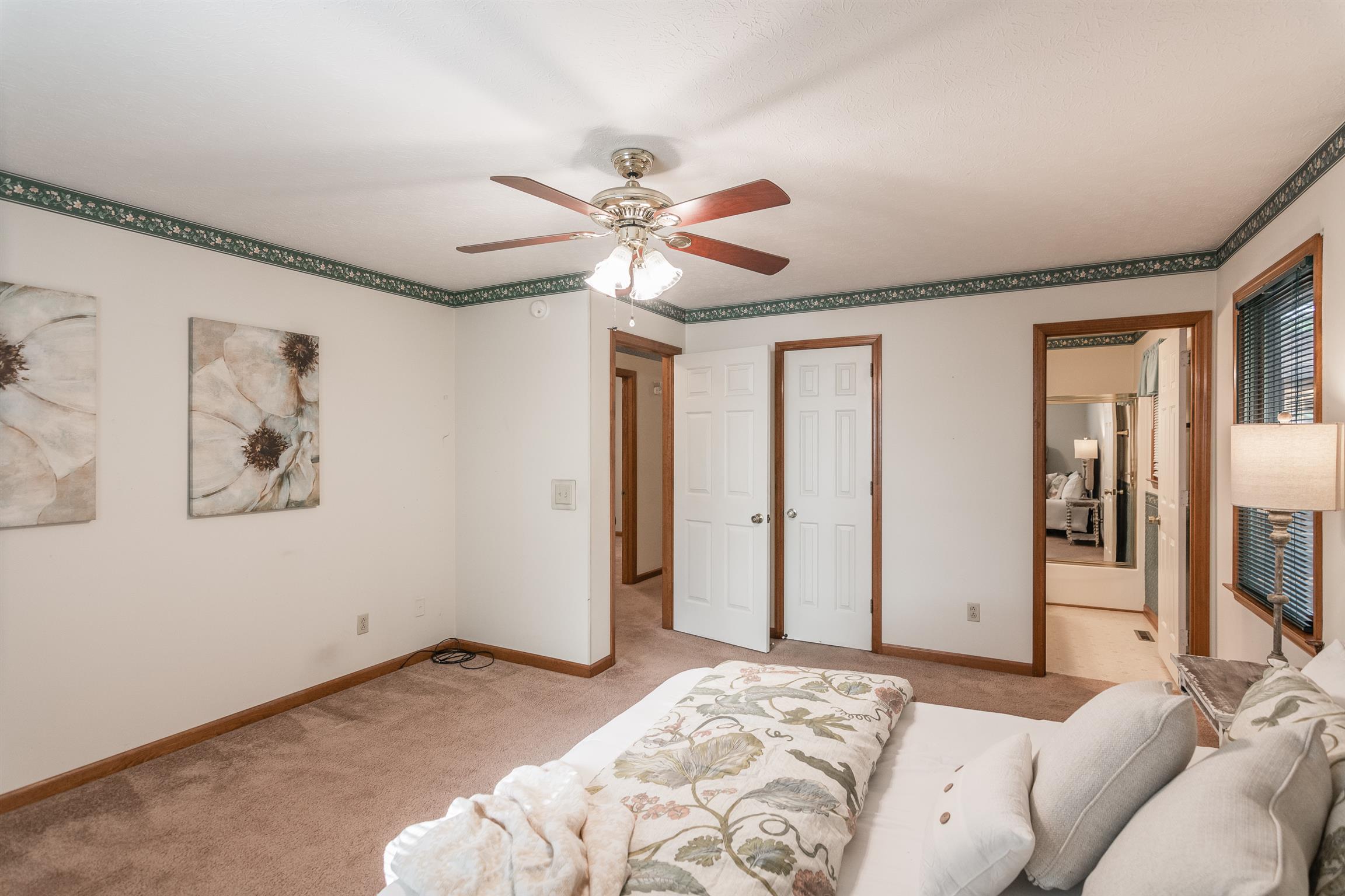 202 Bell Lane Springfield, TN 37172 - Photo 16 of 23 a bedroom with a large bed and a chandelier