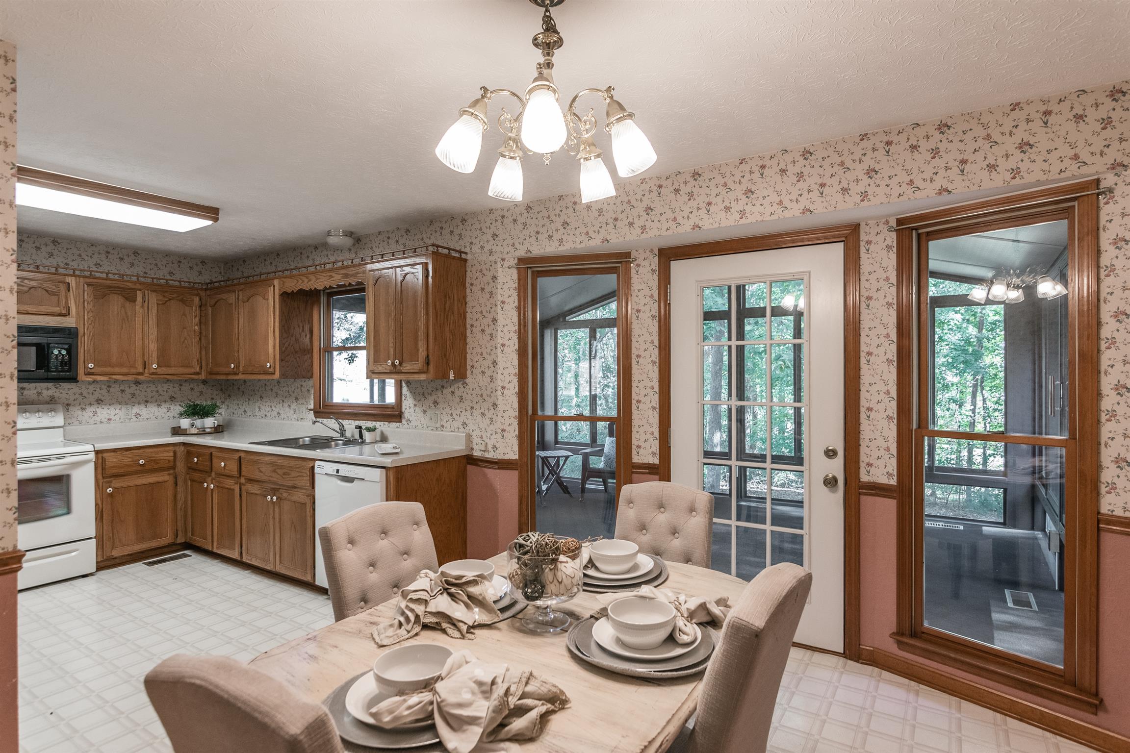 202 Bell Lane Springfield, TN 37172 - Photo 9 of 23 a kitchen with stainless steel appliances granite countertop a stove a sink a dining table and chairs