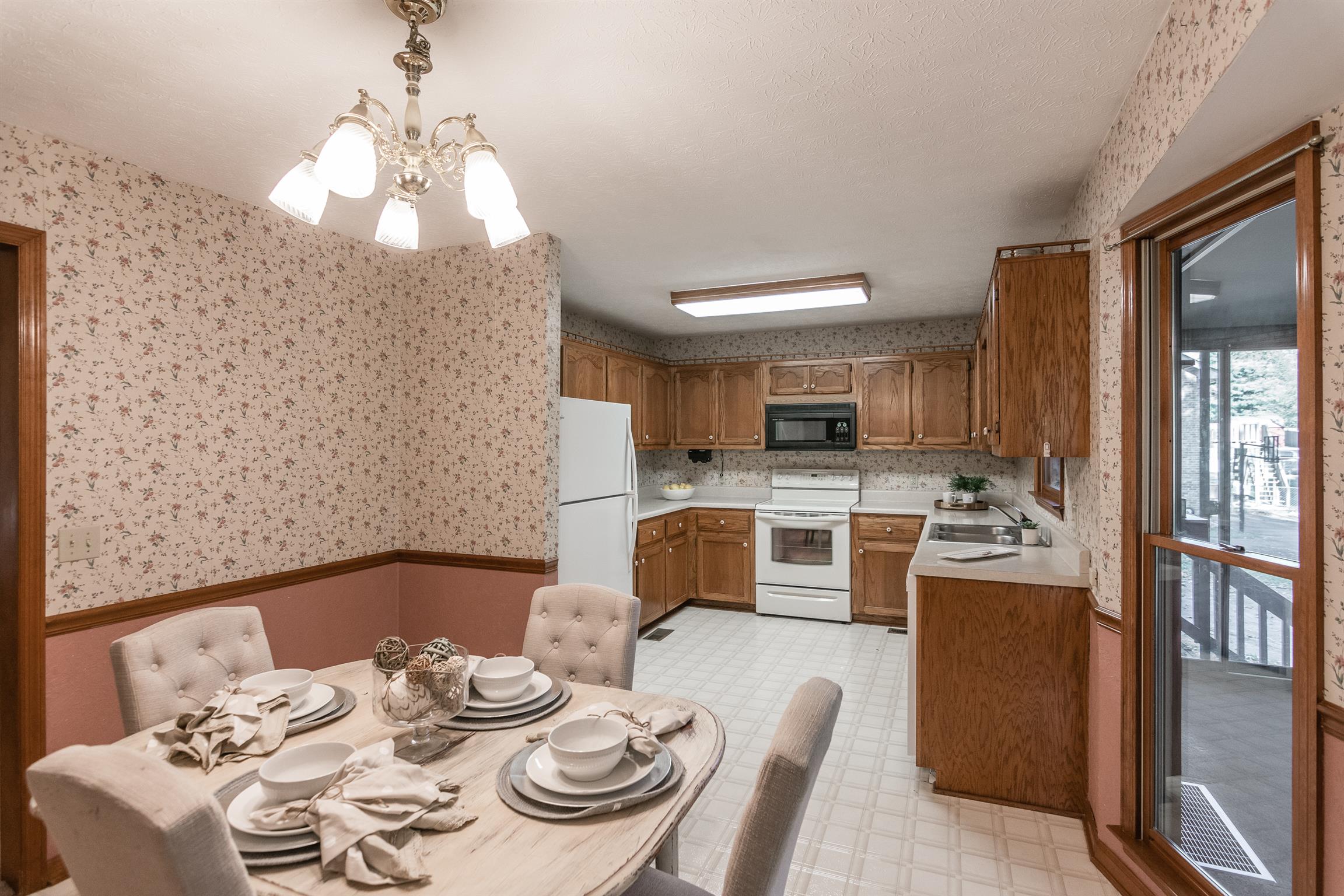 202 Bell Lane Springfield, TN 37172 - Photo 10 of 23 a view of a dining room with furniture a kitchen and chandelier