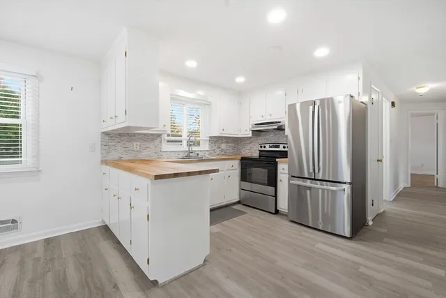 a kitchen with a refrigerator and a sink