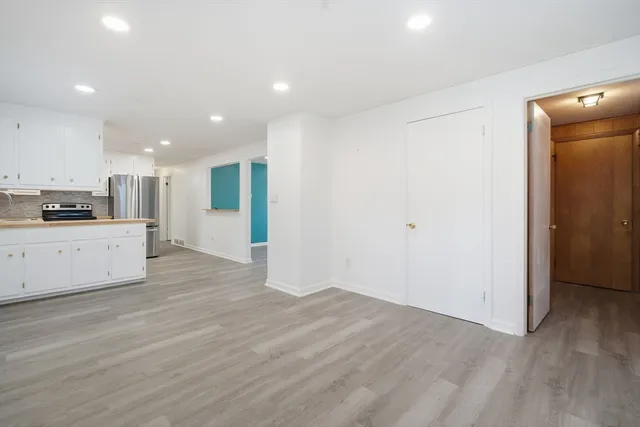 a view of a kitchen with a sink and a refrigerator