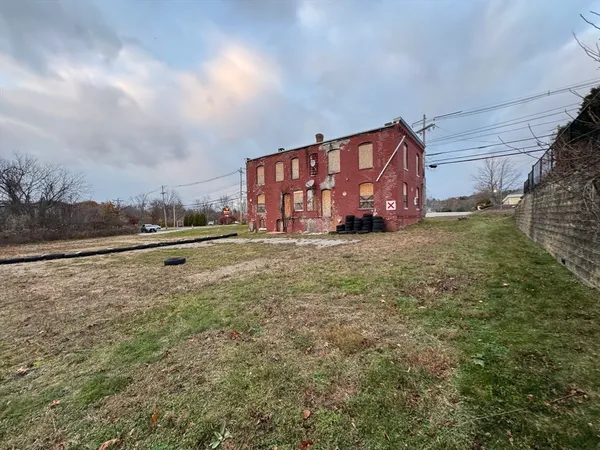 a view of a big yard with an trees