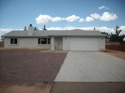 12580 Pocono Road Apple Valley, CA 92308 - Photo 1 of 1 a front view of a house with a yard