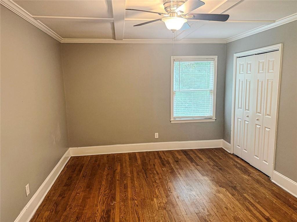 4330 Stonewall Tell Road Atlanta, GA 30349 - Photo 25 of 39 wooden floor in an empty room with a window