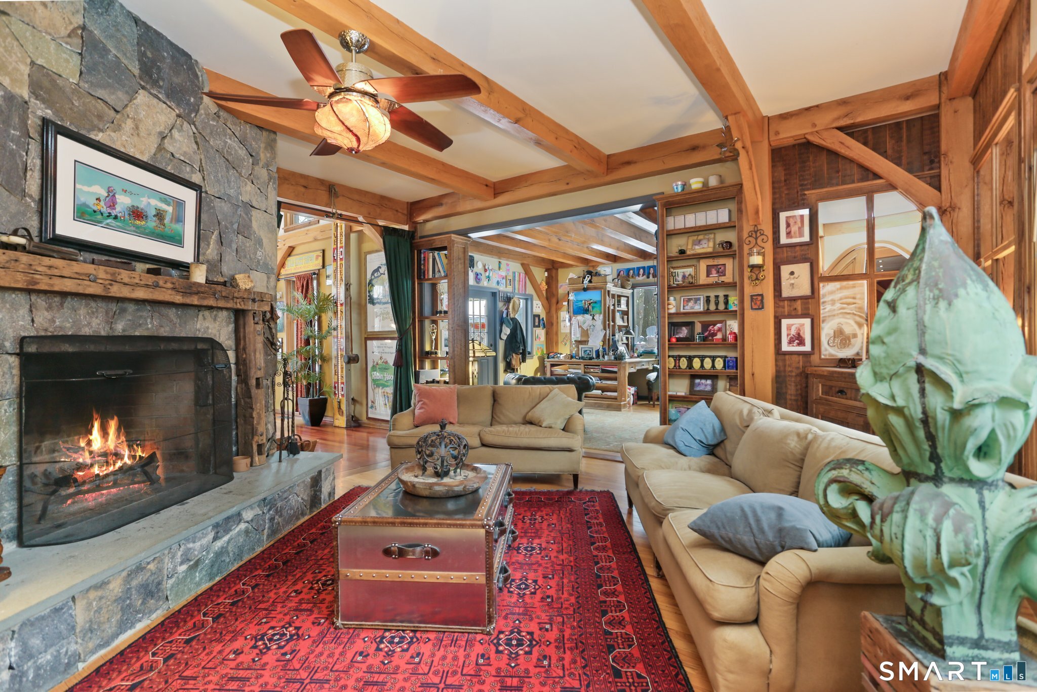 142 Seventy Acre Road Redding, CT 06896 - Photo 7 of 40 a living room with furniture a fireplace and a flat screen tv