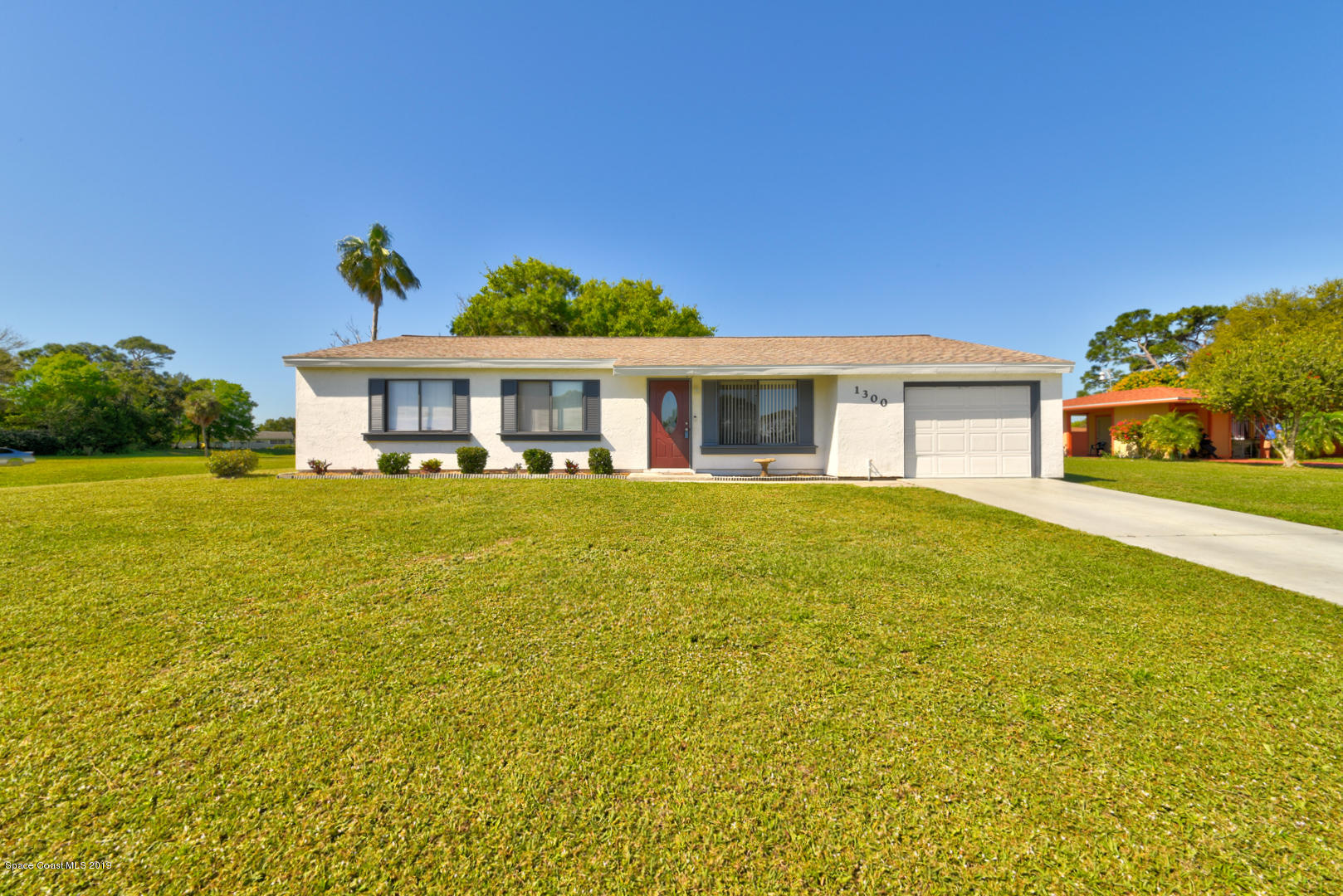1300 Cromey Road Northeast Palm Bay, FL 32905 - Photo 1 of 29 a view of a house with a swimming pool
