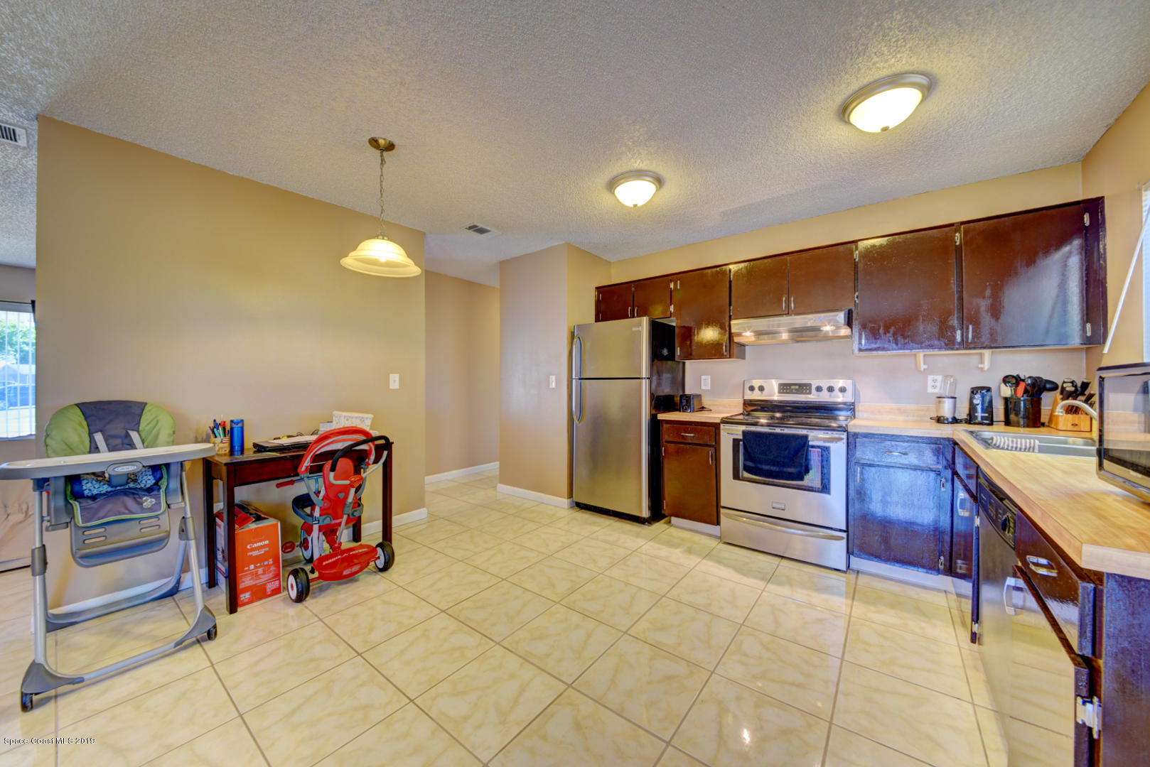 1300 Cromey Road Northeast Palm Bay, FL 32905 - Photo 11 of 29 a kitchen with stainless steel appliances granite countertop a refrigerator and a stove