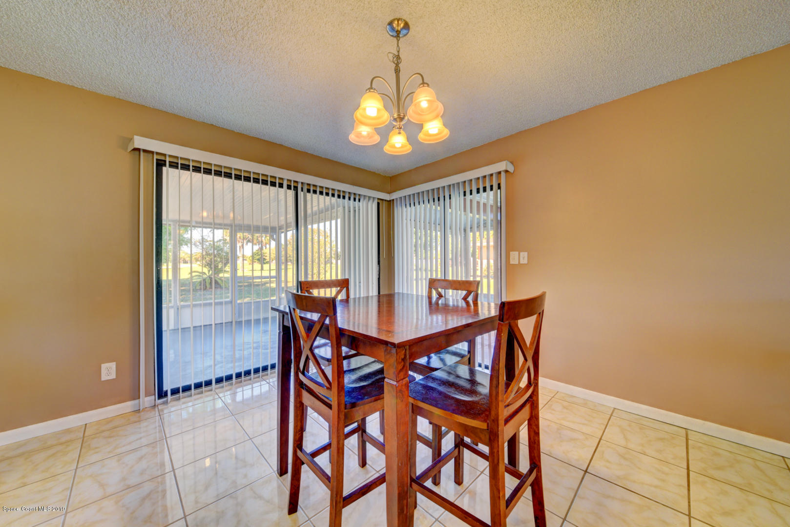 1300 Cromey Road Northeast Palm Bay, FL 32905 - Photo 15 of 29 a view of a dining room with furniture and chandelier
