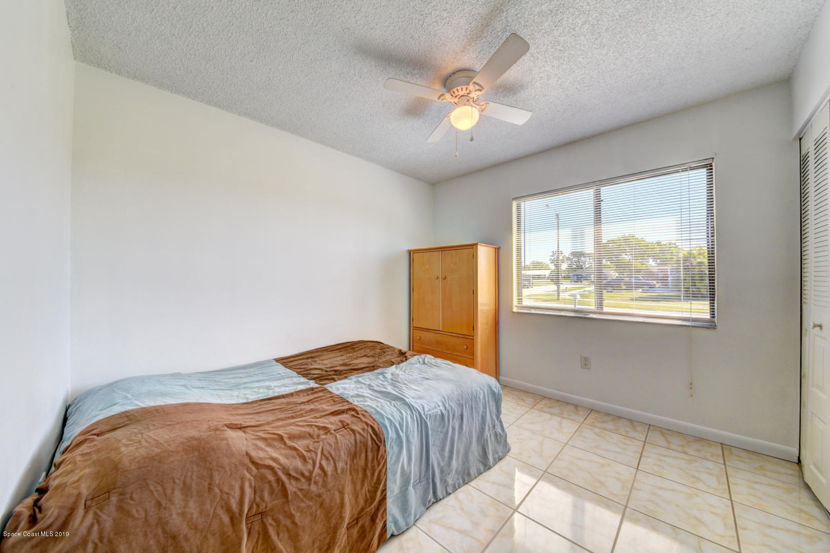 1300 Cromey Road Northeast Palm Bay, FL 32905 - Photo 20 of 29 a bedroom with a bed and a window