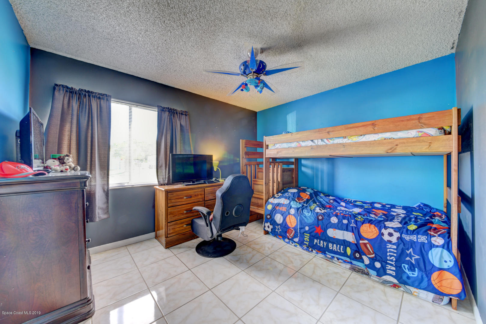 1300 Cromey Road Northeast Palm Bay, FL 32905 - Photo 23 of 29 a bedroom with furniture and a baby crib