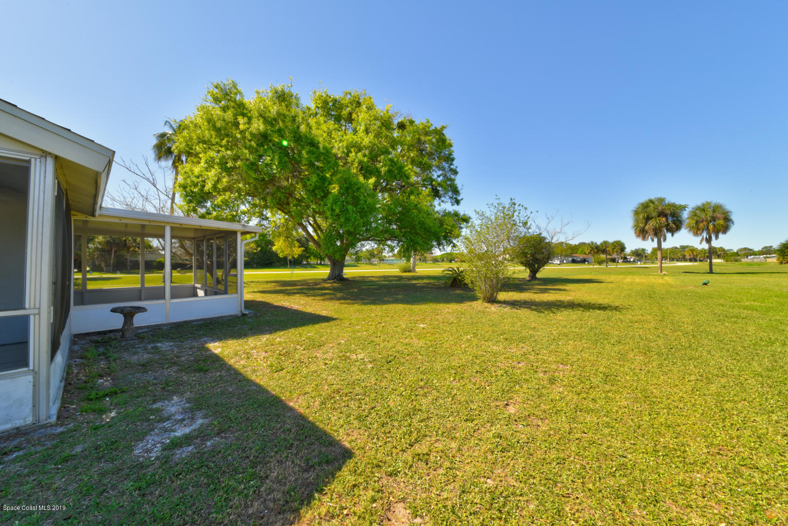 1300 Cromey Road Northeast Palm Bay, FL 32905 - Photo 28 of 29 a view of a swimming pool with an outdoor space and seating area