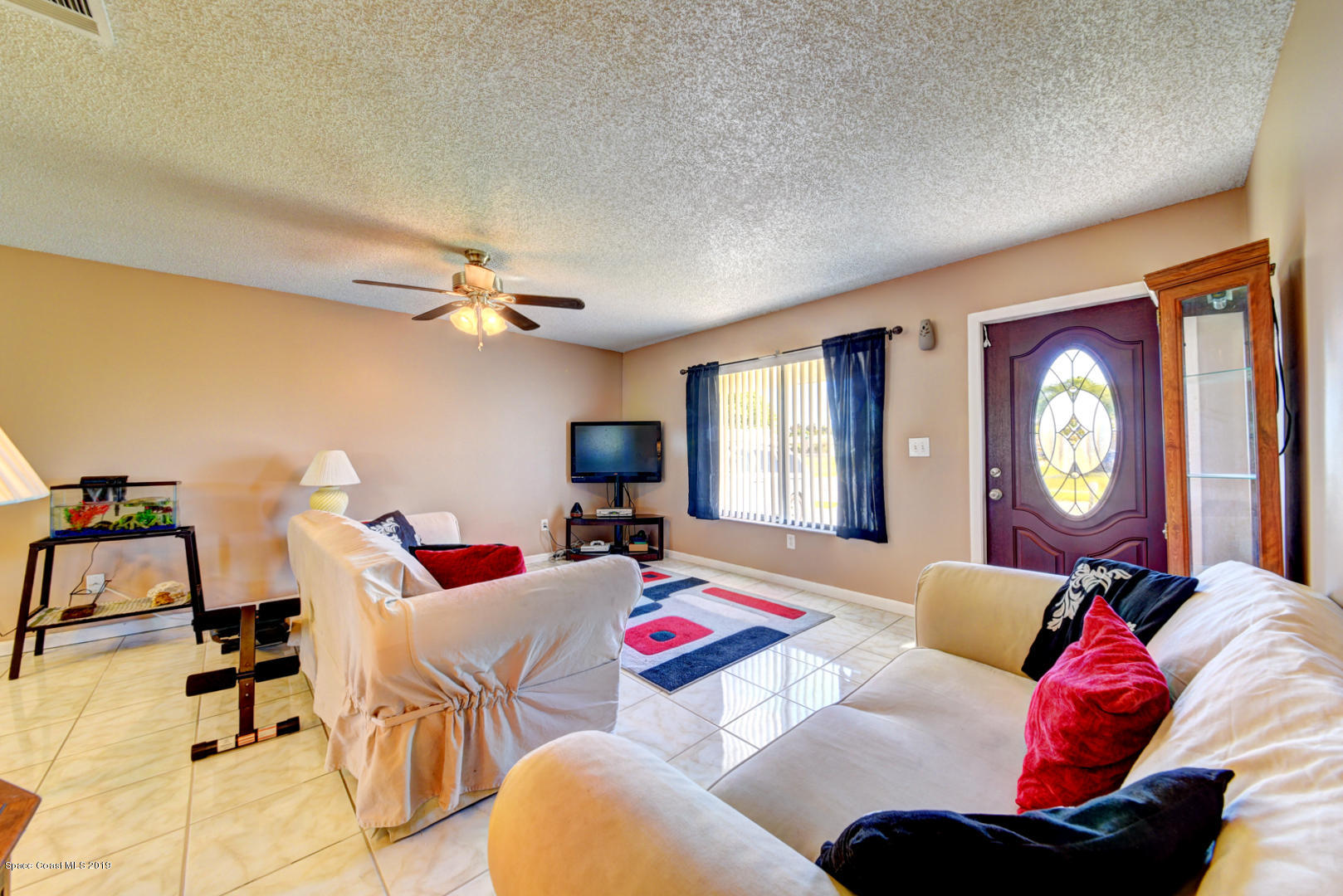 1300 Cromey Road Northeast Palm Bay, FL 32905 - Photo 5 of 29 a living room with furniture and a large window