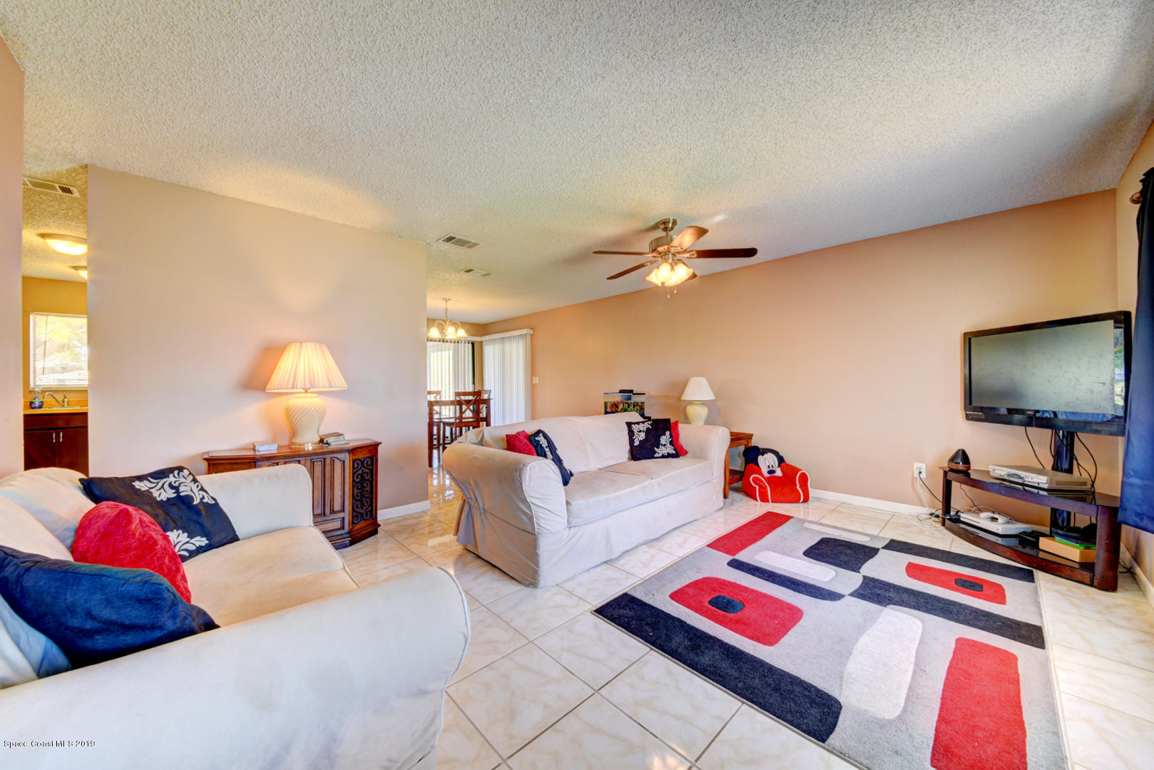 1300 Cromey Road Northeast Palm Bay, FL 32905 - Photo 7 of 29 a living room with furniture and a flat screen tv