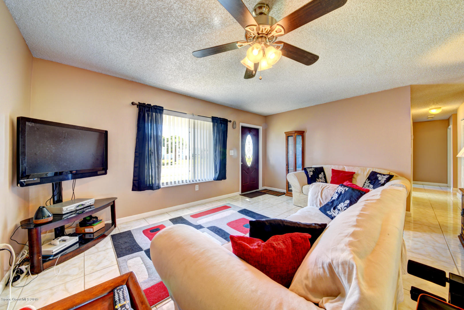 1300 Cromey Road Northeast Palm Bay, FL 32905 - Photo 8 of 29 a living room with furniture and a flat screen tv