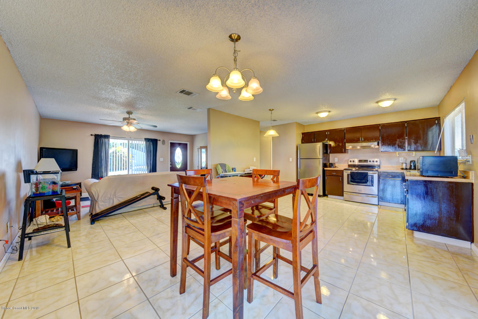 1300 Cromey Road Northeast Palm Bay, FL 32905 - Photo 10 of 29 a view of a dining room with furniture and a chandelier