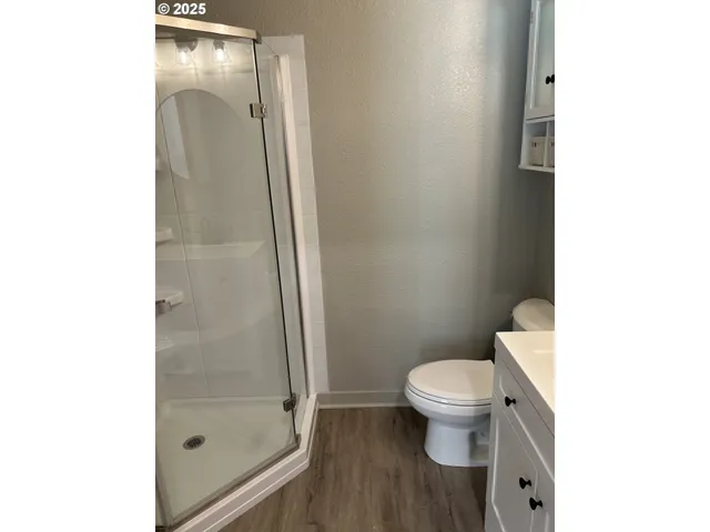a bathroom with a toilet and a shower