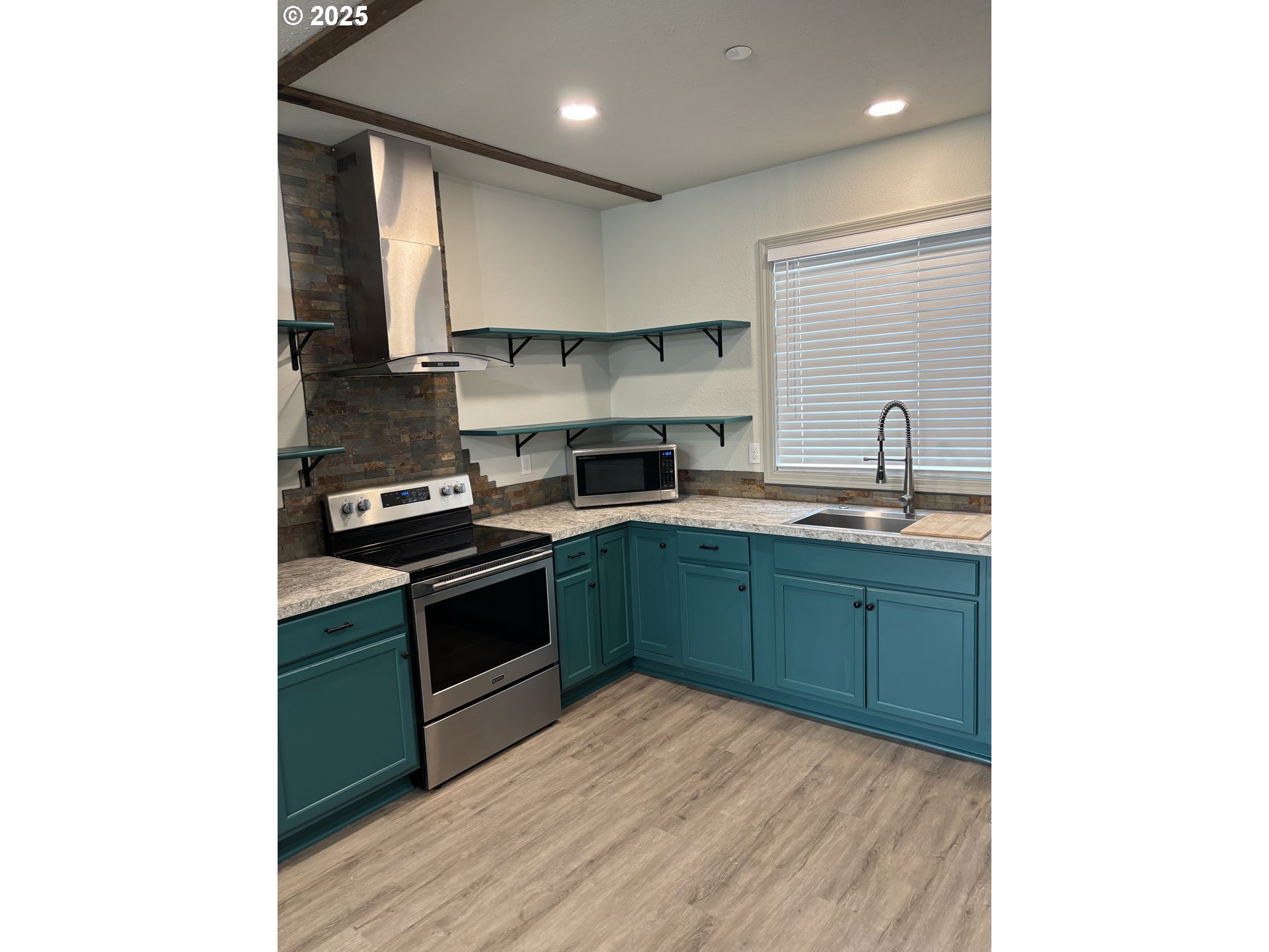704 Patrol Street Molalla, OR 97038 - Photo 2 of 29 a kitchen with stainless steel appliances granite countertop a sink and cabinets