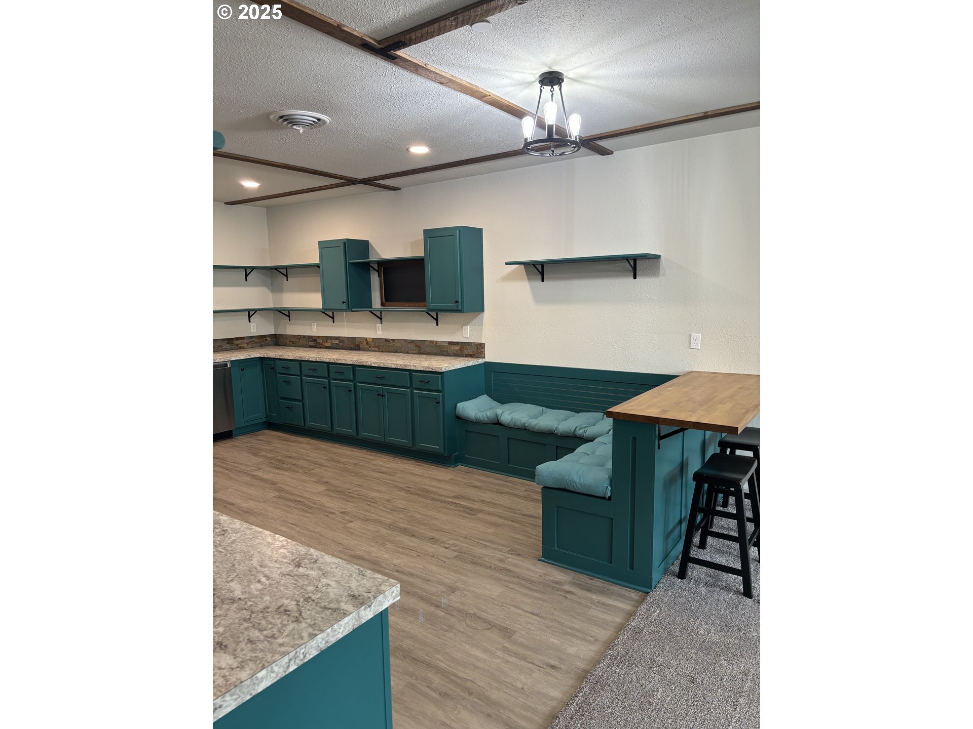 704 Patrol Street Molalla, OR 97038 - Photo 4 of 29 a kitchen with kitchen island a sink stainless steel appliances and cabinets