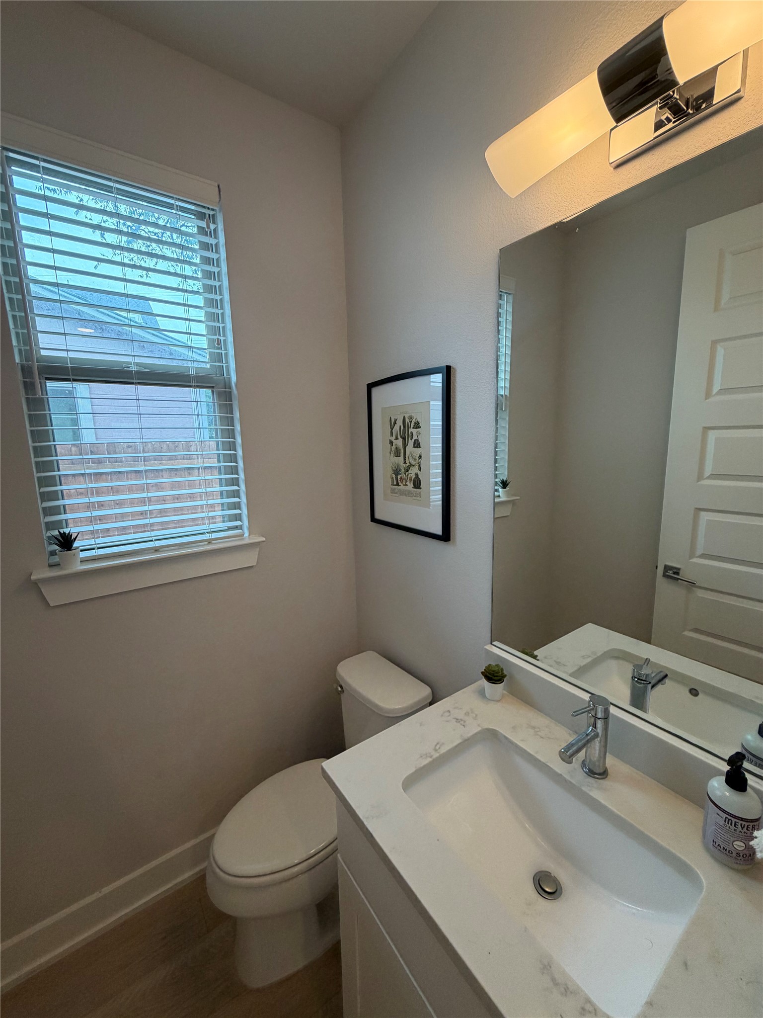 1159 Webberville Road, Unit A Austin, TX 78721 - Photo 13 of 26 Half bathroom featuring vanity and dark wood-style flooring