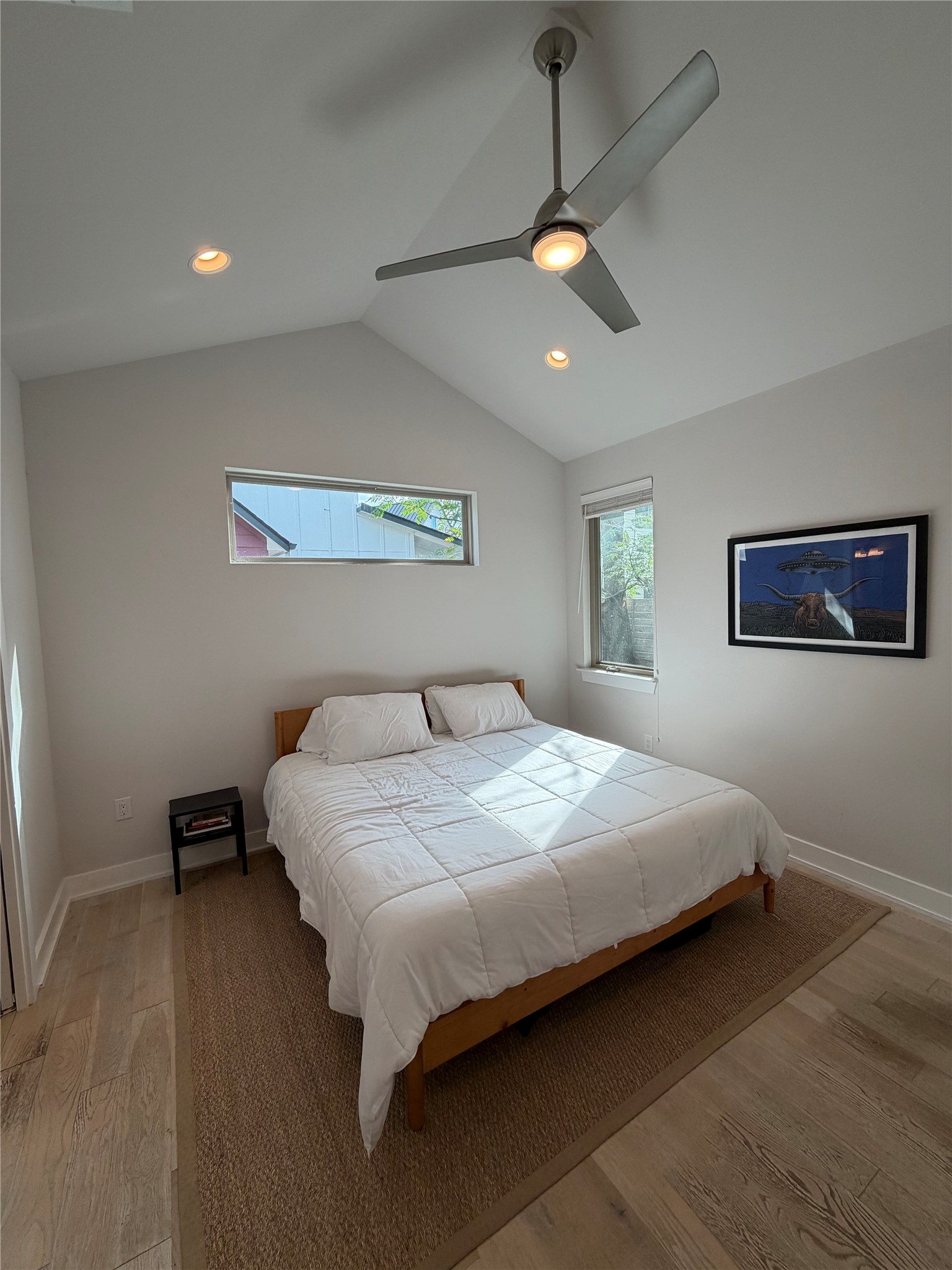 1159 Webberville Road, Unit A Austin, TX 78721 - Photo 16 of 26 Bedroom featuring vaulted ceiling, light wood-style flooring, ceiling fan, and recessed lighting