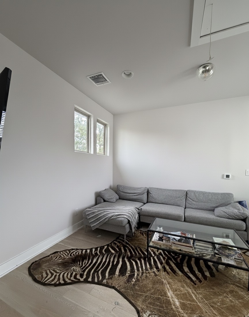 1159 Webberville Road, Unit A Austin, TX 78721 - Photo 20 of 26 Living area featuring wood finished floors, attic access, and recessed lighting