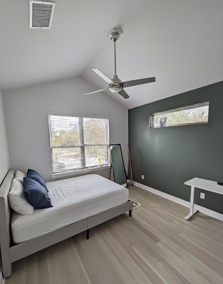 1159 Webberville Road, Unit A Austin, TX 78721 - Photo 21 of 26 Bedroom featuring vaulted ceiling, light wood-style flooring, and a ceiling fan