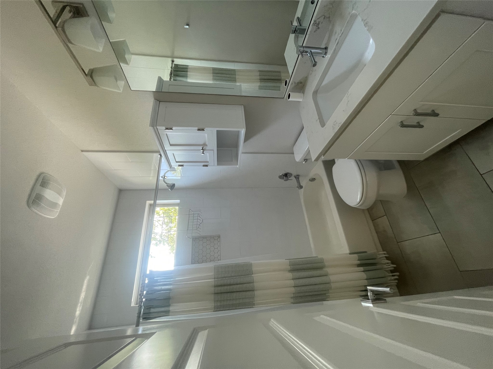 1159 Webberville Road, Unit A Austin, TX 78721 - Photo 22 of 26 Bathroom featuring shower / bath combo, vanity, and light tile patterned floors