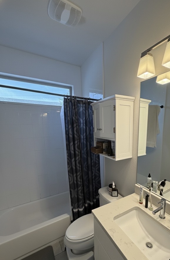 1159 Webberville Road, Unit A Austin, TX 78721 - Photo 23 of 26 Bathroom featuring shower / bath combination with curtain and vanity