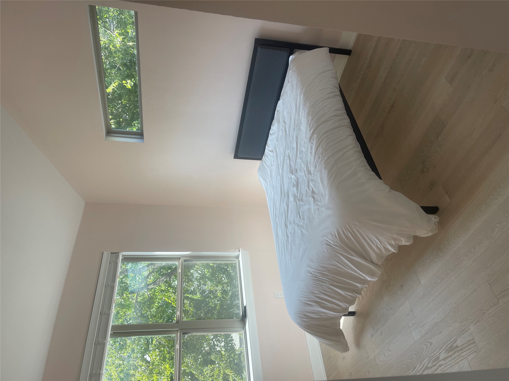 1159 Webberville Road, Unit A Austin, TX 78721 - Photo 24 of 26 Bedroom with lofted ceiling and wood finished floors