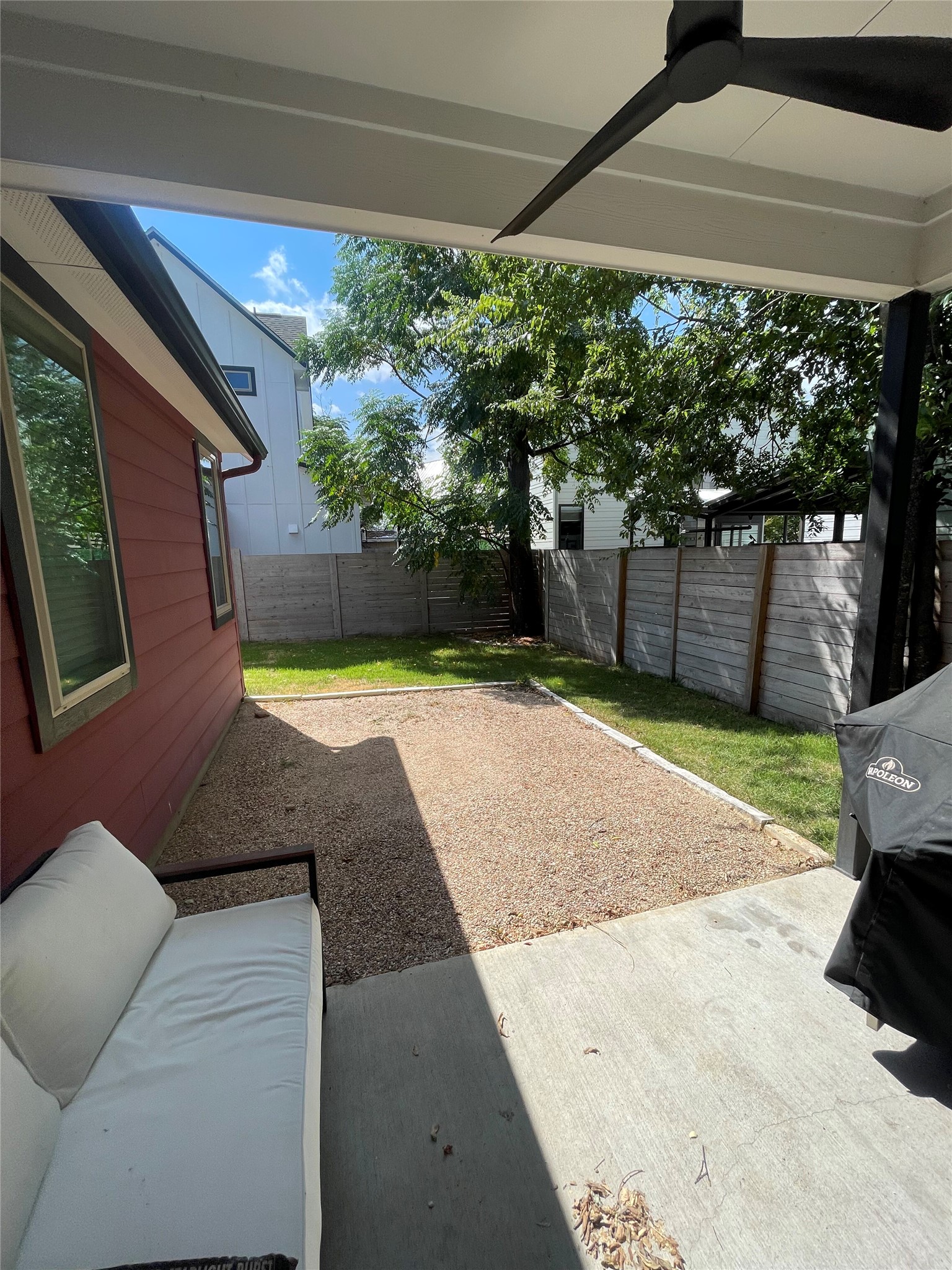 1159 Webberville Road, Unit A Austin, TX 78721 - Photo 25 of 26 Fenced backyard featuring a patio area and ceiling fan
