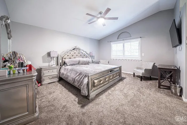 a bedroom with a bed a chair and a fireplace